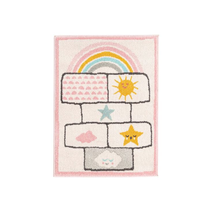 a white rug with stars, clouds and rainbows on the top is shown in front of a white background