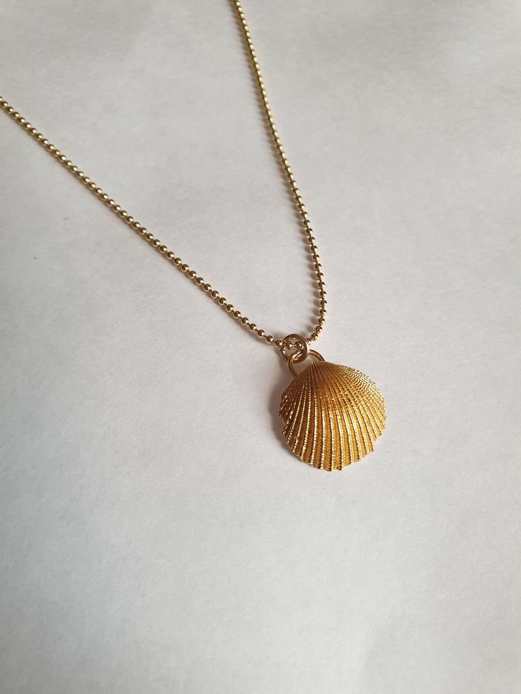 A sea shell necklace made of natural shells casted in brass and plated with quality, nickel free 14k gold plating. The necklace is made of 14k gold filled. Gold Minimalist Necklace For Beach, Minimalist Gold Necklaces For The Beach, Minimalist Gold Necklace For Beach, Dainty Gold Shell Jewelry, Gold Shell Necklace With Ocean-inspired Style, Gold Shell Necklace Ocean-inspired, Gold Shell Ocean-inspired Necklace, Gold Ocean-inspired Shell Necklace, Ocean-inspired Gold Shell Charm Necklace