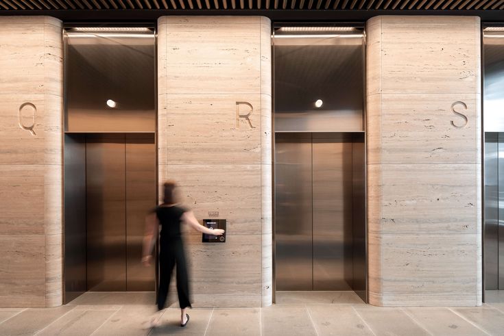 a woman is walking through an elevator