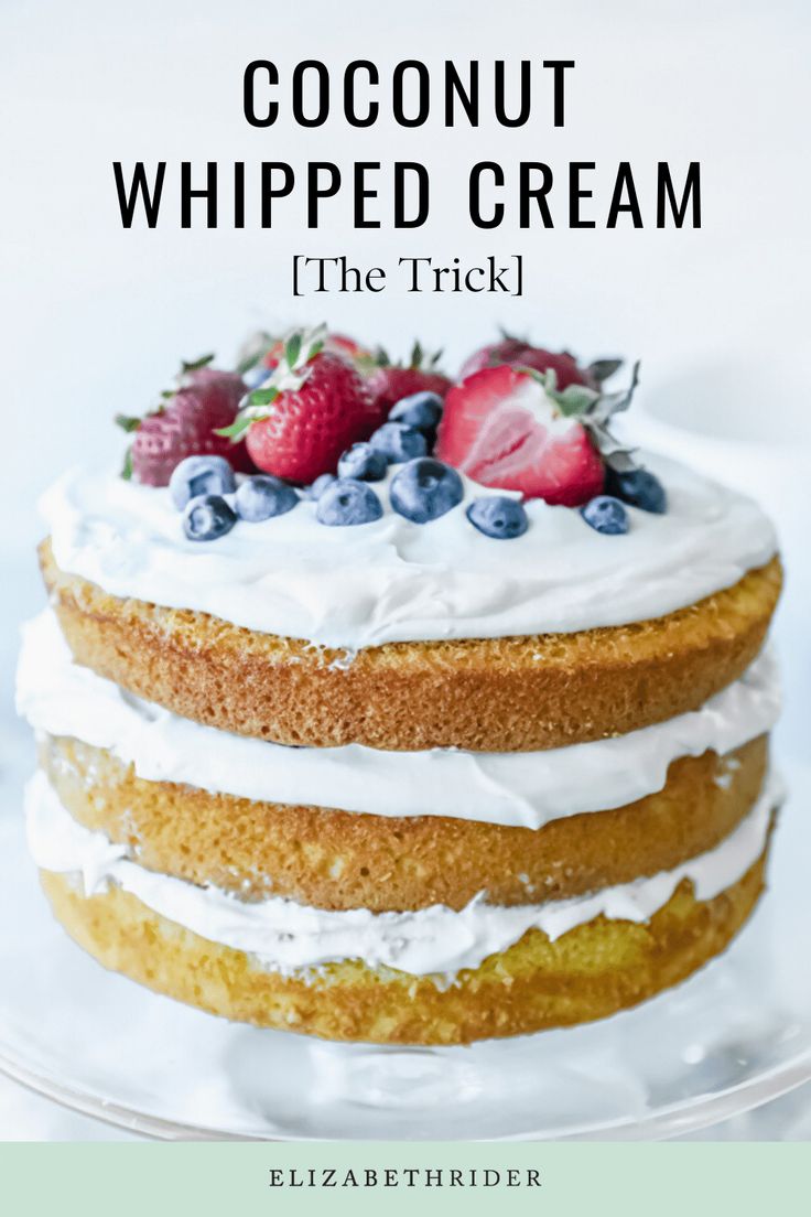 a close up of a cake with white frosting and berries on top that says coconut whipped cream the trick