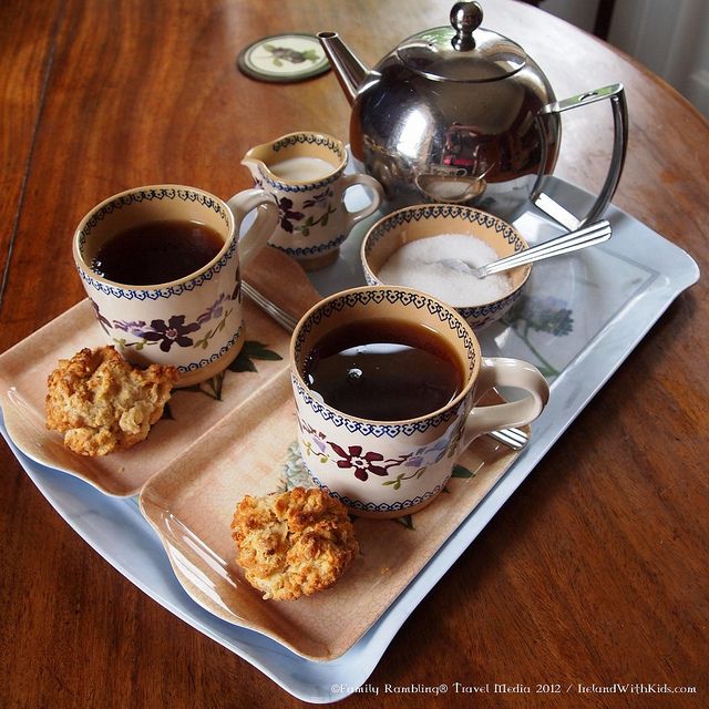 two cups of tea and some cookies on a tray