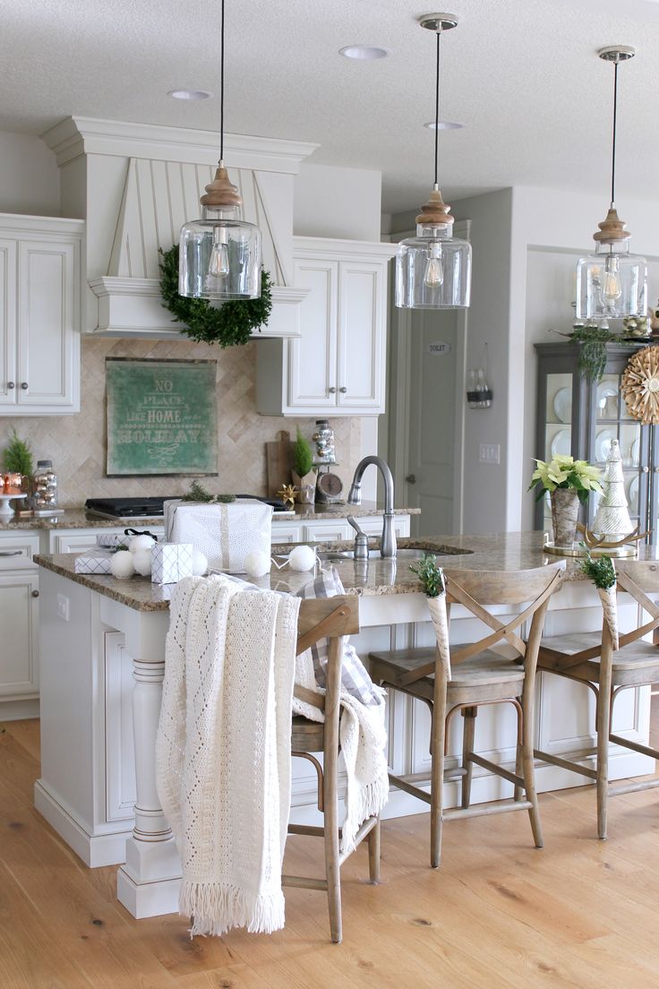 the kitchen is decorated in white and has lots of counter space for dining or entertaining