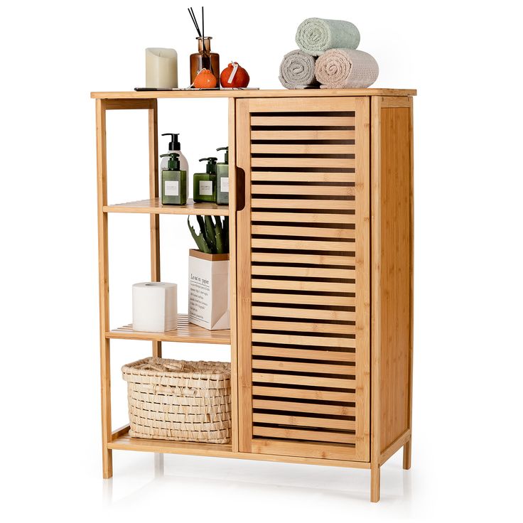 a wooden cabinet with shelves and towels on top