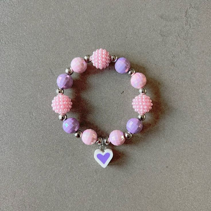 Pink bracelet for girl kid beaded bracelet for kids purple heart bracelet pink beads necklace for children heart charm bracelet gift for kid This delightfully cute Kids bracelet is perfect for your little one! Constructed with an elastic cord, it is both easy and safe for your child to put on and take off. The colorful pink and purple beads, paired with the heart charm, make this bracelet the perfect accessory for your kid. Item Details *Material: Acrylic, Rice beads, Silicone *Bracelet size: 5i Purple Round Beaded Jewelry For Mother's Day, Purple Round Bead Jewelry For Valentine's Day, Purple Round Beads Jewelry For Valentine's Day, Playful Pink Jewelry With Colorful Beads, Playful Heart Beads For Jewelry Making, Playful Heart-shaped Colorful Beads Jewelry, Cute Heart Beads Beaded Bracelets For Valentine's Day, Cute Heart Beaded Bracelets For Valentine's Day, Pink Charm Bracelet With Round Beads For Friendship