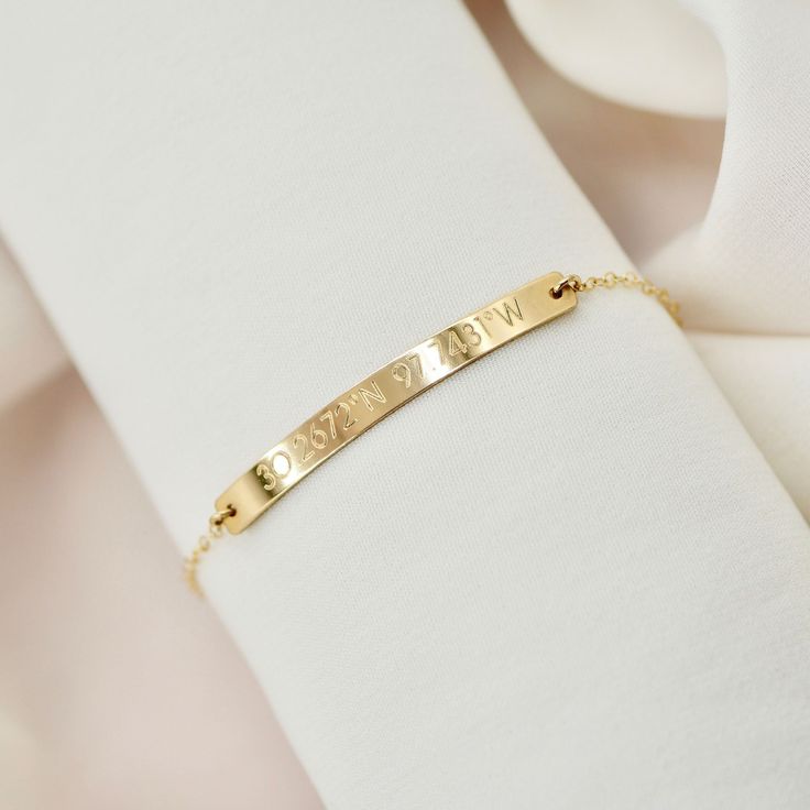 "Coordinate bracelet in 14kt gold filled, rose gold filled or sterling silver. Choose a location that means the most to you! We can also engrave the back with initials or a short saying, just include it in your notes when you check out. This little bar bracelet is engraved with the location of your choice with a Longitude and Latitude . Won't fade, chip or discolor. Wear it all day, everyday! We never take ours off! :) Makes a great gift for bridesmaids, family, friends or a bride-to-be! DETAILS Personalized Sterling Silver Rose Gold Bracelet, Personalized Rose Gold Sterling Silver Bracelets, Dainty Custom Name Bracelet In 14k Gold, Dainty Engraved Bracelets For Everyday Wear, Dainty Engraved Bracelets For Everyday, Dainty Engraved Bracelet For Everyday Wear, Dainty 14k Gold Bracelet With Custom Name, Dainty Everyday Engraved Bracelets, Dainty Rose Gold Name Bracelet In Sterling Silver