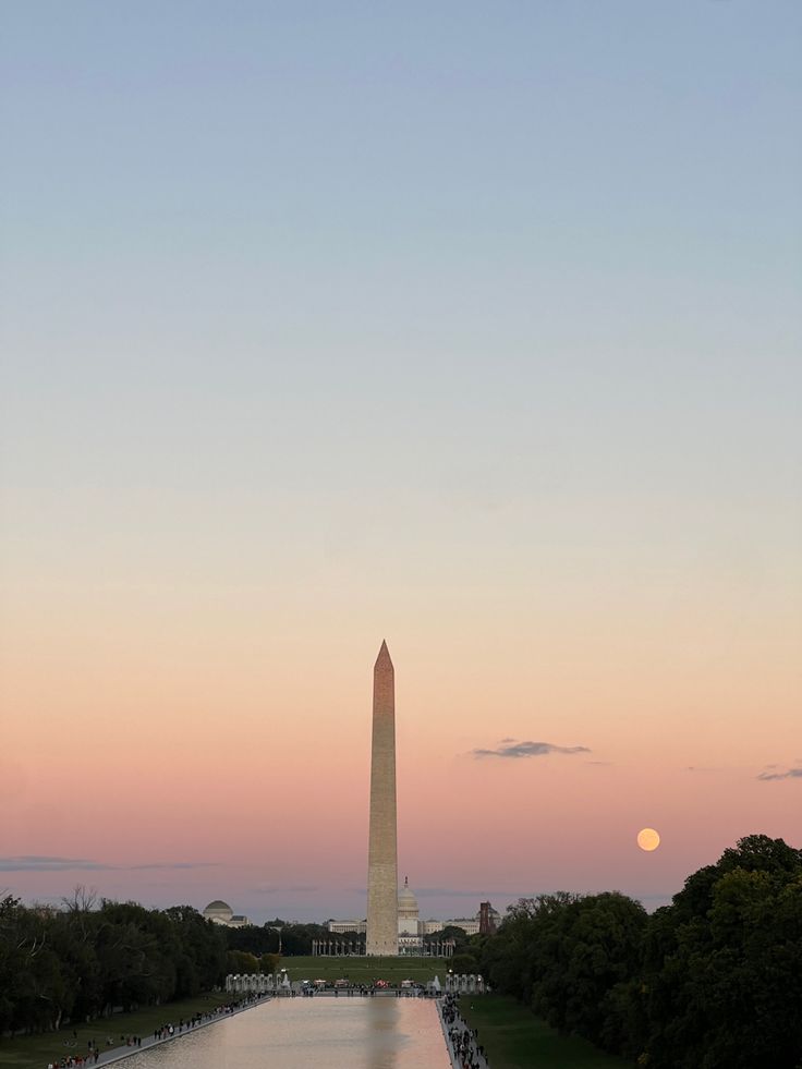 the washington monument and reflecting pool at sunset