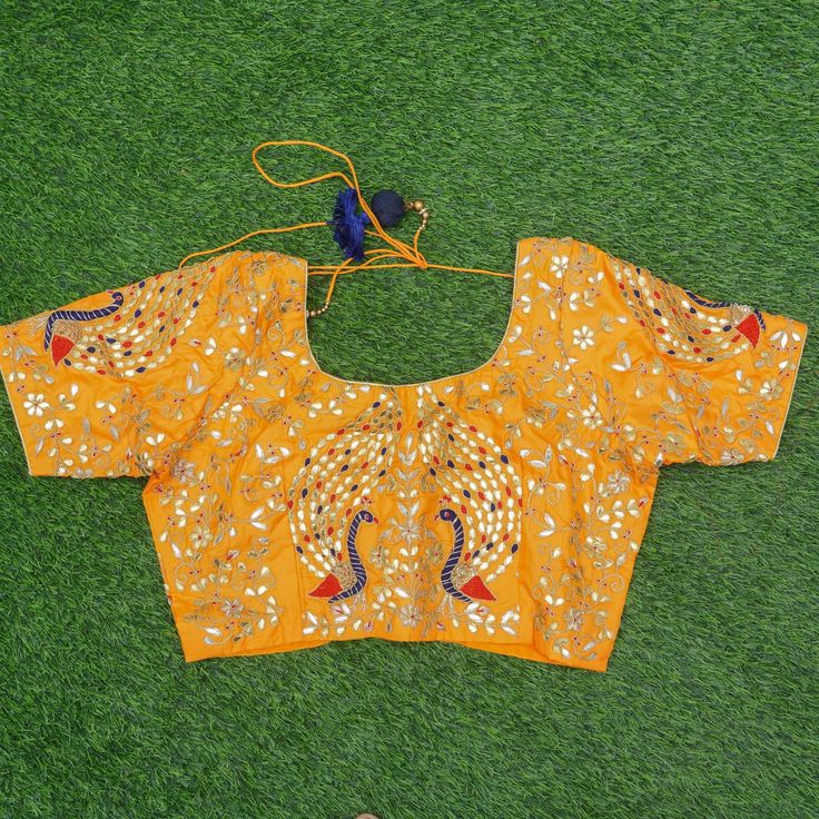 Category: Banarasi Fabric Khinkhwab brings you beautiful fabrics with intricate gotta patti embroidery. All the measurements are shown in the picture. This is 38 chest blouse. Non-padded. Fabric: Pure Silk Note- There may be slight color variations due to photographic reasons. This is a hand-woven product and any irregularities in the weaving or pattern should not be taken as a defect. These irregularities make every handloom piece unique. Raw Silk Embroidered Top For Diwali, Designer Cutdana Embroidered Top, Festive Designer Embroidered Top With Traditional Drape, Anarkali Embroidered Top With Dori Work, Designer Resham Embroidery Top For Eid, Festive Designer Embroidered Top With Mirror Work, Designer Resham Embroidered Top For Eid, Festive Designer Mirror Work Embroidered Top, Diwali Semi-stitched Resham Embroidered Top