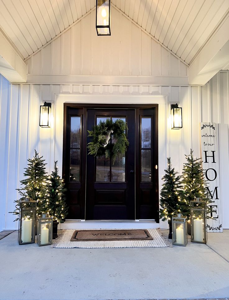 the front door is decorated with christmas trees and candles