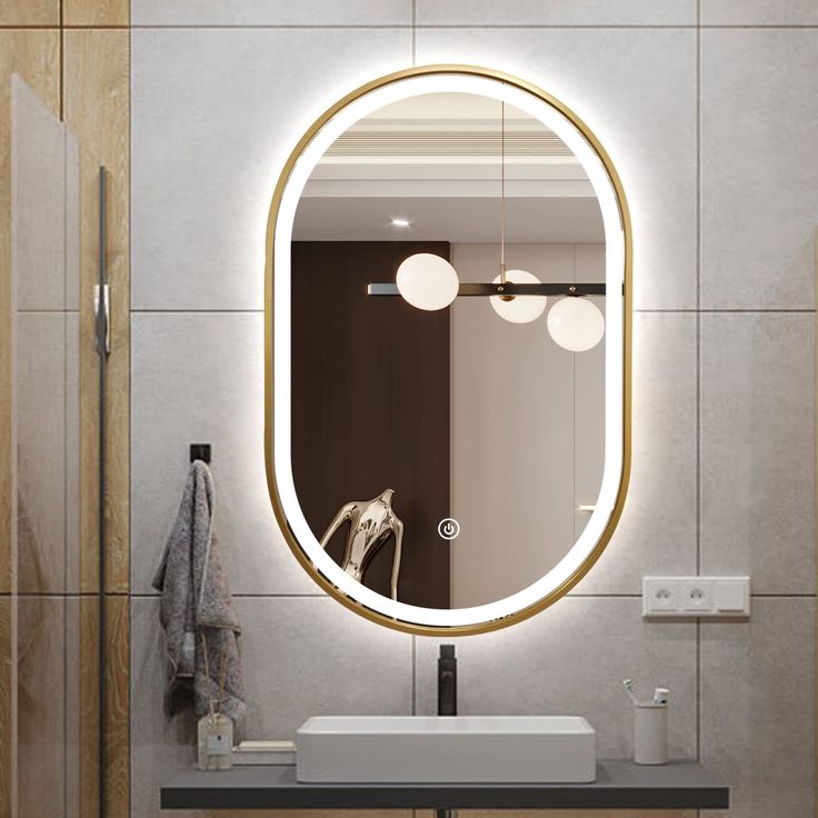 a bathroom with a sink, mirror and lights on the wall in front of it