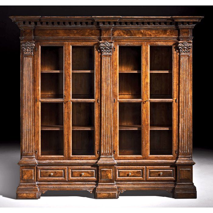 an old wooden bookcase with two doors and three drawers on the front, against a black background