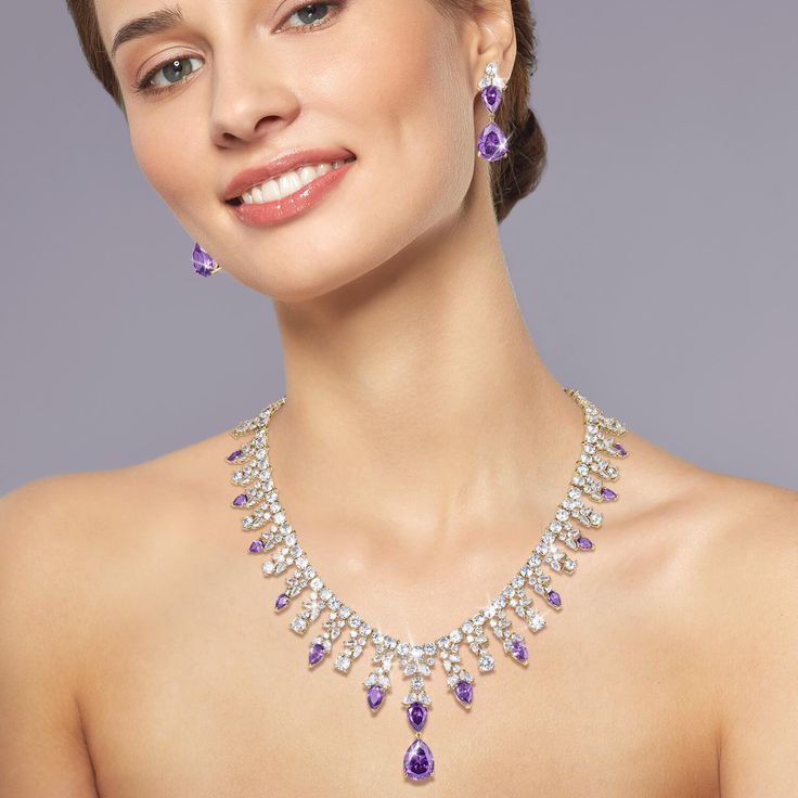 Indulge yourself in this shimmering bonanza. This collection oozes style and sophistication and is sure to make you stand out in a crowd. The mount is expertly set with shimmering, deep regal purple and ice white Diamondeau®, flawless simulated diamond. The collection is given a truly decadent feel with a glimmering golden finish. Complete the look with the matching earrings making you statement ready for the festive season. Elegant Purple Jewelry For Evening, Elegant Purple Evening Jewelry, Luxury Purple Jewelry For Party, Purple Luxury Jewelry For Party, Elegant Purple Jewelry For Formal Occasions, Elegant Lavender Jewelry For Evening, Elegant Lavender Evening Jewelry, Dazzling Purple Jewelry With Diamond Accents, Elegant Purple Jewelry With Diamond Accents