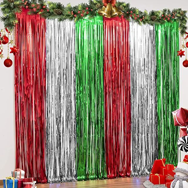 a room decorated for christmas with red, green and silver tinsel curtain backdrops