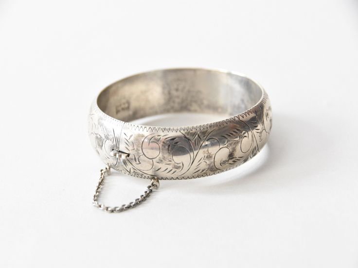 "Antique victorian sterling silver bangle. Etched scroll design all around. Markings inside (hard to make out). Push release clasp and a safety chain. Light patina but can be polished if desired. A great addition to any bracelet stack. Condition | good, two small indentations, refer to photos. request further photos if needed. Measurements ✂--- Best fit | inner circumference 2 1/2\" Markings | present but hard to make out ★★Visit The Shop★★ http://www.etsy.com/shop/seaofvintage ➸ Find the shop o Victorian Style Engraved Silver Bangle, Victorian Style Silver Engraved Bangle, Victorian Silver Engraved Bangle, Victorian Sterling Silver Engraved Wedding Bracelet, Engraved Antique Silver Cuff Bracelet For Weddings, Ornate Engraved Wedding Bangle, Ornate Engraved Bangle For Wedding, Engraved Sterling Silver Bracelet For Wedding, Etched Sterling Silver Bangle Bracelet For Wedding