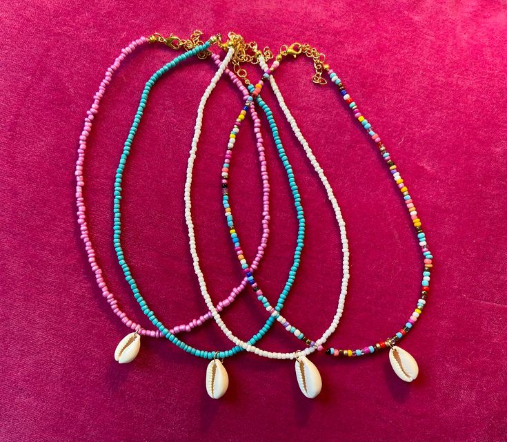 These beautiful boho beads with a shell pendant at beach vibes to any outfit and can be wore everyday anywhere. They can be layered up or wore solo, either way they are the perfect addition to any look. Bohemian Shell-shaped Jewelry With Colorful Beads, Beach Shell Jewelry With Tiny Beads, Colorful Shell Bead Necklaces For Vacation, Colorful Beads Shell Necklace For Vacation, Bohemian Shell With Colorful Beads For Gift, Bohemian Shell With Colorful Beads, Colorful Shell Bead Necklaces For Beach, Beach Shell Necklaces With Colorful Beads, Colorful Beaded Shell Necklaces For Vacation