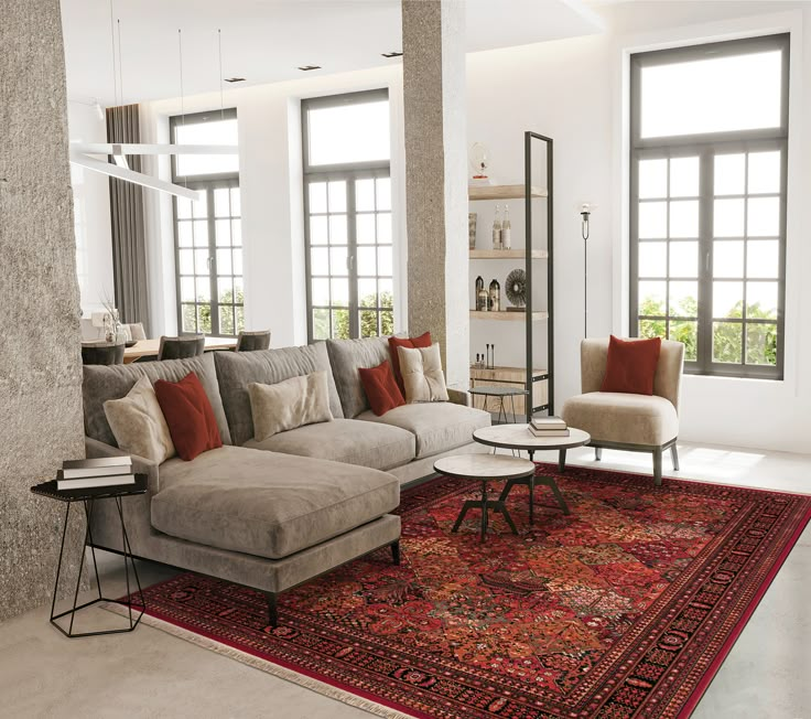 a living room filled with lots of furniture next to windows and a rug on the floor