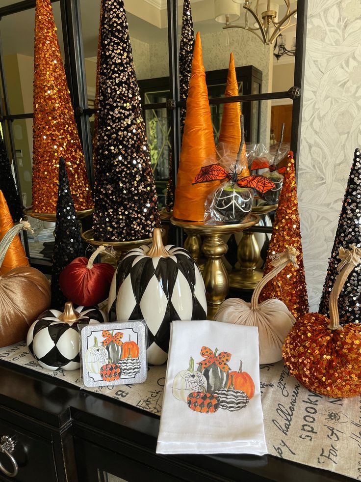 a table topped with lots of different types of pumpkins and other decorative items on top of it