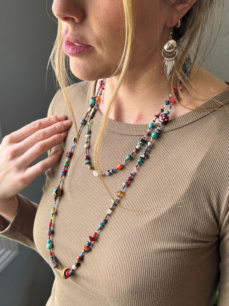 Step into a world of vibrant colors and exquisite materials with our Long Wrap Southwestern Boho Necklace! This handcrafted masterpiece is made up of gemstones and materials. Turquoise, known for its healing properties and connection to the sky; coral, a symbol of vitality and protection; clay beads that echo the earth's simplicity and warmth; lapis, for wisdom and truth; pearls, representing purity and integrity; glass beads that capture the light of life; sterling silver for strength and resilience; and crystals that bring clarity and energy. T Designed with versatility in mind, this necklace invites you to express your style in countless ways. Wrap it loosely for a casual, laid-back look, or layer it for an elegant, sophisticated touch. Its intricate craftsmanship and the blend of mater Long Necklace Boho, Southwestern Boho, Bohemian Accessories, Hippie Necklace, Light Of Life, Healing Properties, Clay Beads, Handmade Artisan, Boho Necklace