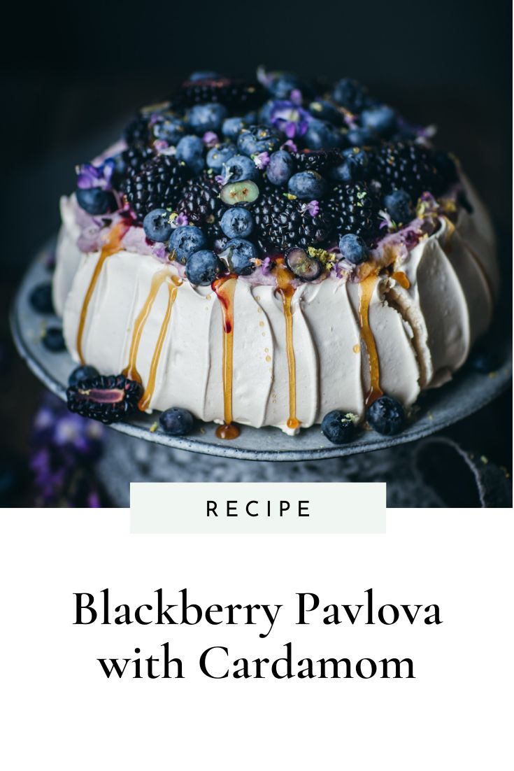 blackberry pavlova with cardamom recipe on a cake platter and text overlay reads recipe