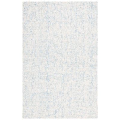 a white and blue rug with small dots on it