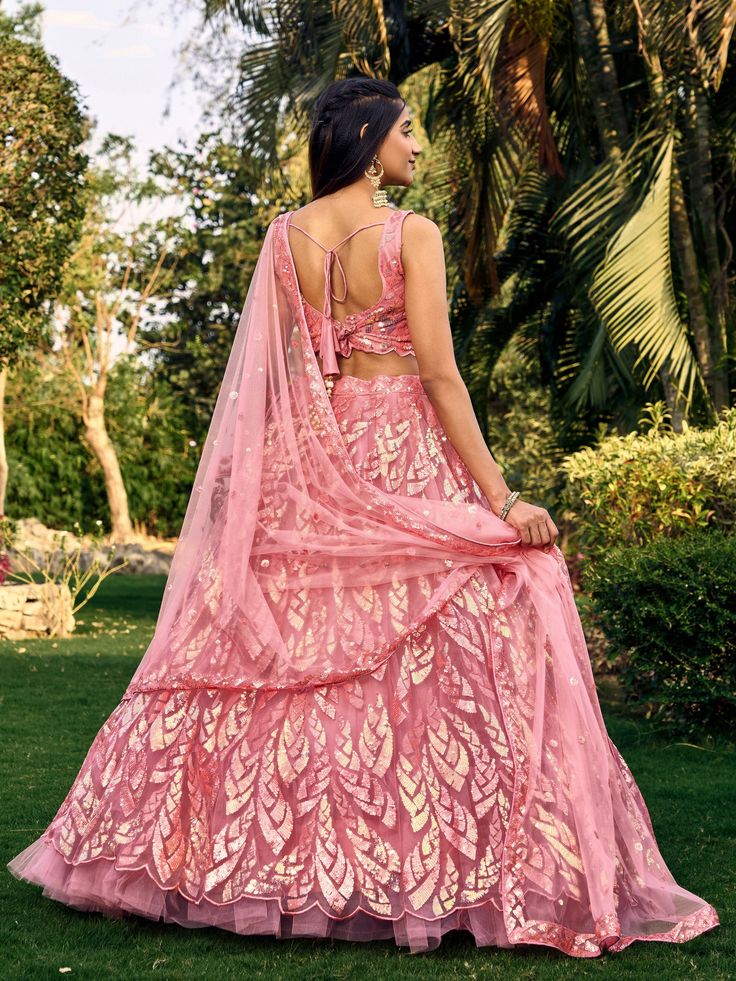 Introducing our stunning "beautiful pink sequins net bridesmaid lehenga choli with dupatta" set, crafted with intricate thread embroidered work and sequin detailing. This beautiful ensemble includes a pink color net material lehenga with matching choli and dupatta, all featuring exquisite embellishments that will surely make you stand out at any wedding or ethnic occasion.
The semi-stitched lehenga can comfortably fit up to 42 inches and comes with an unstitched choli material for customization. Sequin Net Lehenga For Festivals, Festival Net Lehenga With Sequins, Sequin Net Choli For Festivals, Festival Net Choli With Sequins, Festival Choli With Sequins And Net Material, Festival Sequined Net Choli, Festive Lehenga With Sequins And Net Material, Pink Sequined Saree For Party Wear, Anarkali Net Choli With Sequins