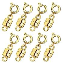 gold plated metal clasps and rings on a white background