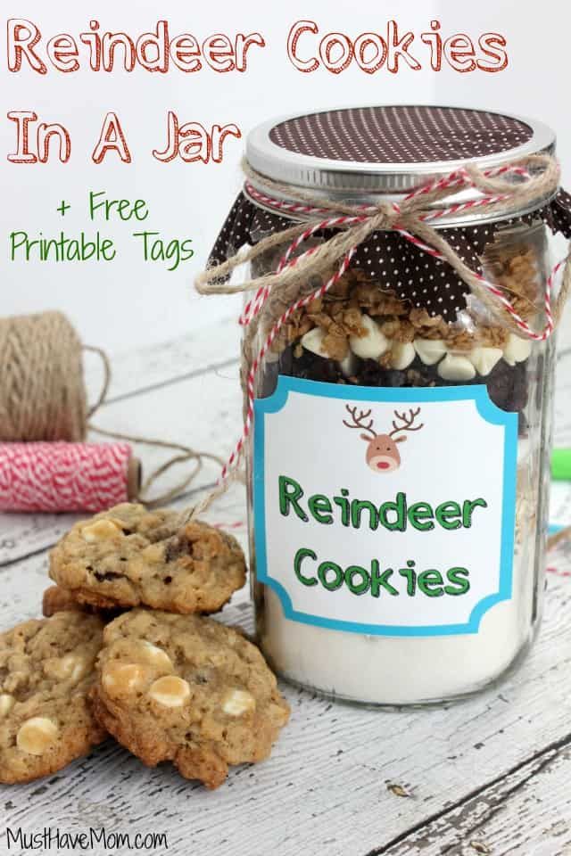 a jar filled with cookies next to a spool of twine