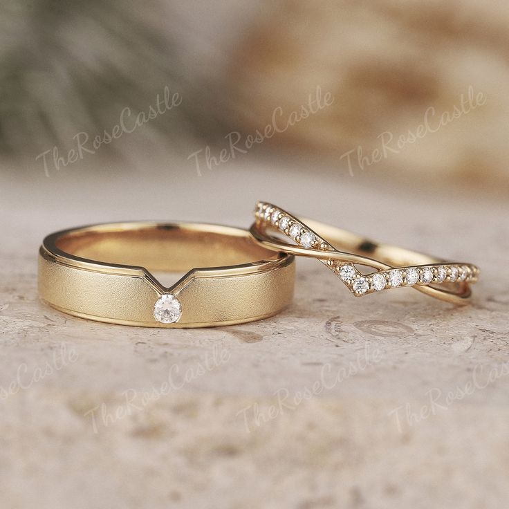 two gold wedding bands with diamonds on them