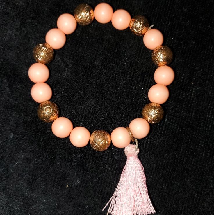 New Without Tags Peach Beaded Stretchy Bracelet With A Tassel Spiritual Pink Beaded Bracelets For Beach, Pink Round Beads Bracelets For Festival, Adjustable Round Beads Bracelets With Tassels, Spiritual Pink Beaded Bracelet For Beach, Pink Stretch Bracelet With Round Beads For Festival, Gift Bracelets With Tassels, Pink Round Beads Stretch Bracelet For Festival, Pink Beaded Bracelets With Faceted Beads For Festival, Pink Beaded Stretch Bracelet For Festivals