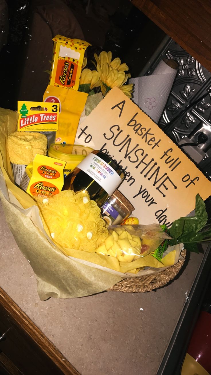 a basket filled with cheese and other food on top of a counter next to a sign