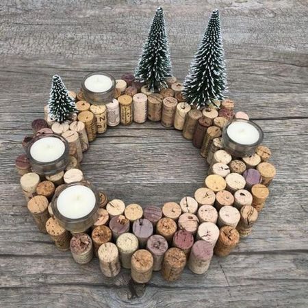 a wreath made out of wine corks with candles and pine trees in the middle