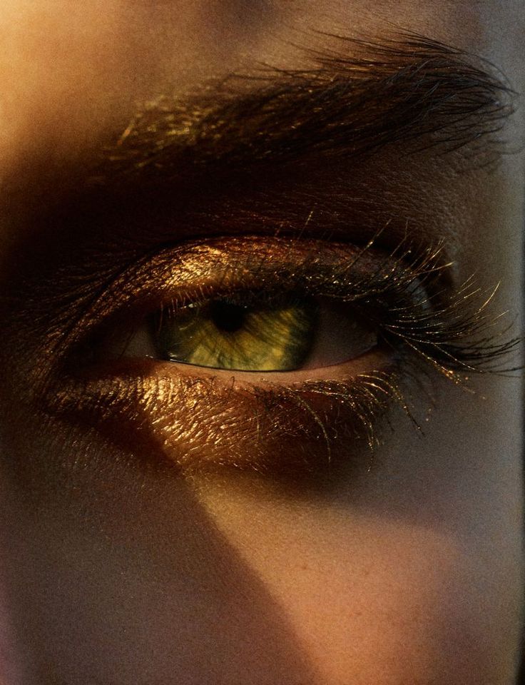 an eye is shown with the reflection of another person's face