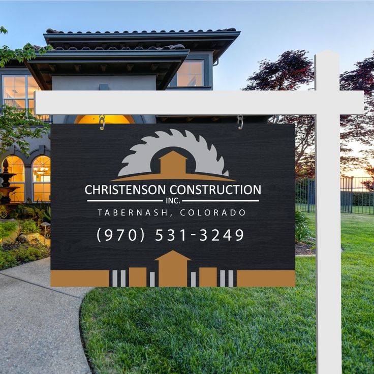 a real estate sign in front of a house with the name christenson construction