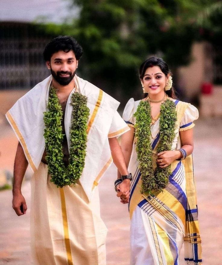 man and woman dressed in traditional garb holding hands