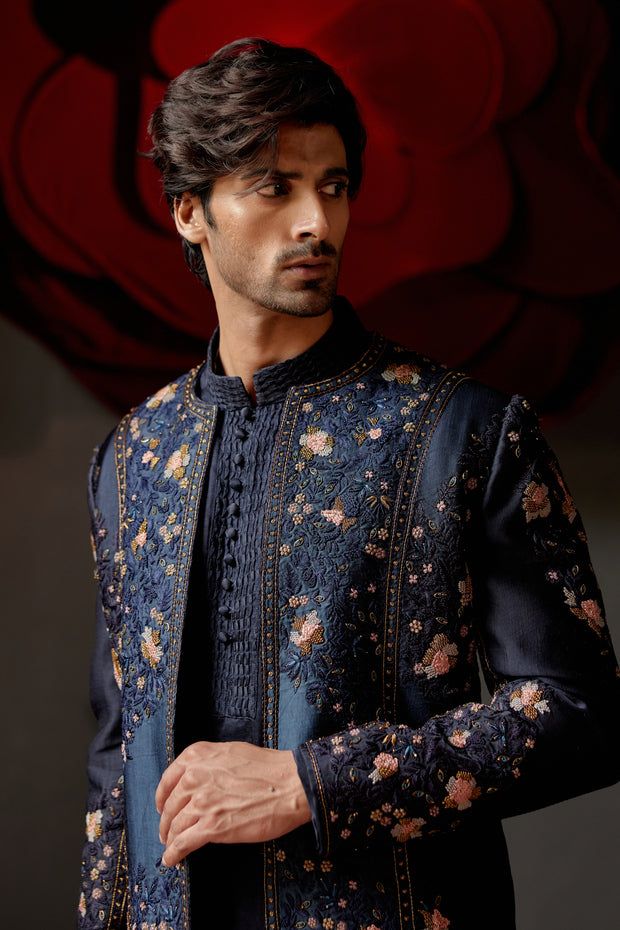 Midnight Omber Short Jacket | Jatin Malik Presenting our Midnight Blue and Teal Ombre Short Jacket, a fusion of elegance and modernity with its captivating color gradient. This jacket is adorned with intricate hand embroidery details, adding a touch of sophistication and charm. Paired seamlessly with a Tone-On-Tone Short Kurta and tapered trousers, this ensemble exudes refined style and versatility. Perfect for various occasions, from formal events to stylish gatherings, this outfit is sure to make a lasting impression with its unique blend of design and craftsmanship. Included in purchase: Short Jacket, Kurta, Trousers Product Specification Color: Midnight blue and teal ombre Fabric: Linen Silk Occasion: Engagement, Wedding, Bridal, Reception Style: Short Jacket, Kurta, Trousers Care: Dry Jatin Malik, Blouse Yoke, Teal Ombre, Kurta Men, Short Kurta, Dress Suits For Men, Indian Man, Tapered Trousers, Indian Wedding Outfits