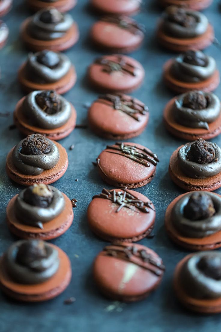 some chocolate covered pastries are sitting on a table