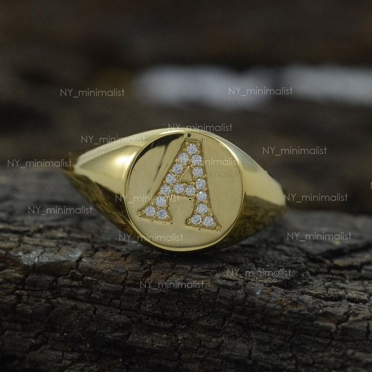 This ring is made with Genuine 0.10 Ct. SI Clarity G-H Color Diamond 'A' Initial Signet Ring Solid 14k Yellow Gold Personalized Party Wear Jewelry/ Bridesmaid Gift. * SKU: SR01012 * Made to Order. * Gold Purity: 14K Solid Yellow Gold (stamped) * Custom Gold Color: Yellow, Rose, White Gold * Custom Gold Purity: 9K/14K/18K (Charges Apply) * Diamond 100% Genuine Diamond * Diamond Weight: 0.10 ct. * Diamond Color: G-H * Diamond Clarity: SI1- SI2 * Diamond Cut: Brilliant Cut (Excellent) Product Measu Diamond Initial Ring In Yellow Gold For Anniversary, Yellow Gold Diamond Initial Ring For Anniversary, Diamond Bezel Setting Signet Ring, Yellow Gold Cubic Zirconia Signet Ring For Anniversary, Anniversary Yellow Gold Diamond Initial Ring, Anniversary Fine Jewelry Initial Ring With Round Cut, Anniversary White Gold Diamond Initial Ring, Personalized Yellow Gold Cubic Zirconia Rings, Personalized Diamond Initial Ring For Anniversary