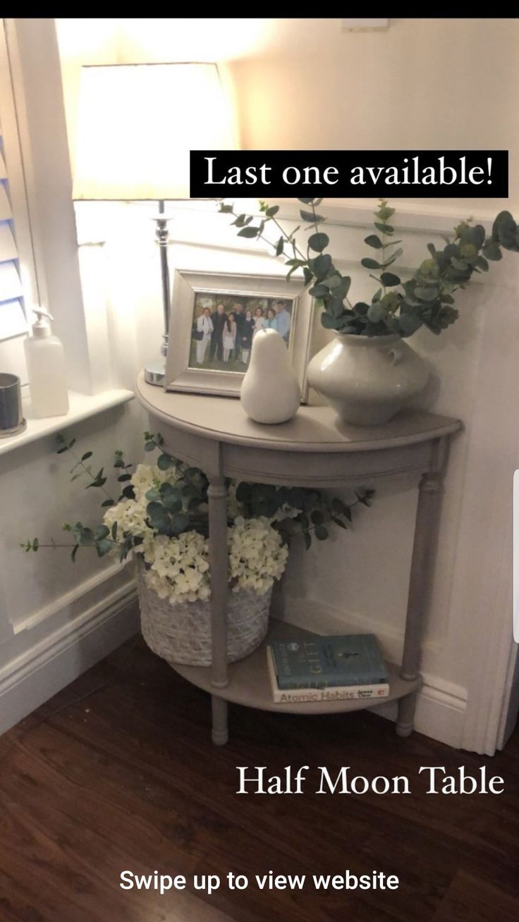 a half moon table with flowers on it