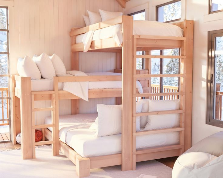 a room with bunk beds and white pillows