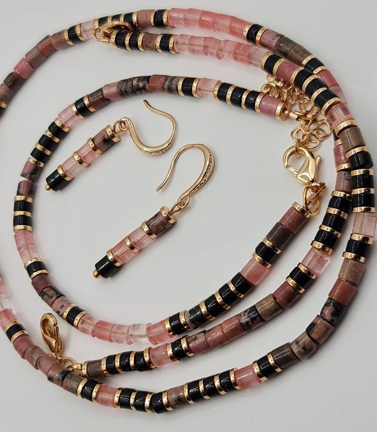 Handmade Natural Rhodonite, black Agate and Watermelon Tourmaline jewelry set. Set of bracelet and earrings.  Rhodonite can be used to calm you during traumatic times. Watermelon Tourmaline will balance your male and female energies. Diameter tube beads 4mm. Set comes in a gift box ready for gifting. You might also like https://www.etsy.com/uk/shop/LoveIuliia?ref=l2-about-shopname§ion_id=42402163 Thank you so much for visiting my shop Iuliia xx Tourmaline Jewelry With Natural Stones For Gifts, Rose Gold Gemstone Beads Jewelry For Gift, Rose Gold Jewelry With Gemstone Beads For Gift, Tourmaline Jewelry With Round Beads As Gift, Tourmaline Natural Stones Bracelets As Gift, Adjustable Tourmaline Gemstone Beads Jewelry, Dangle Tourmaline Jewelry As Gift, Tourmaline Dangle Jewelry For Gifts, Handmade Tourmaline Bracelet