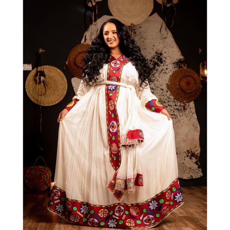 A Stunning Habesha Kemis with Elegant Tilf Embroidery , Habesha Kemis, Eritrean dress, ሀበሻ Ethiopian Pattern, Ethiopian Fashion, Eritrean Dress, Habesha Kemis, Cultural Festival, Wedding Art, Draped Fabric, Vibrant Red, Wedding Couples