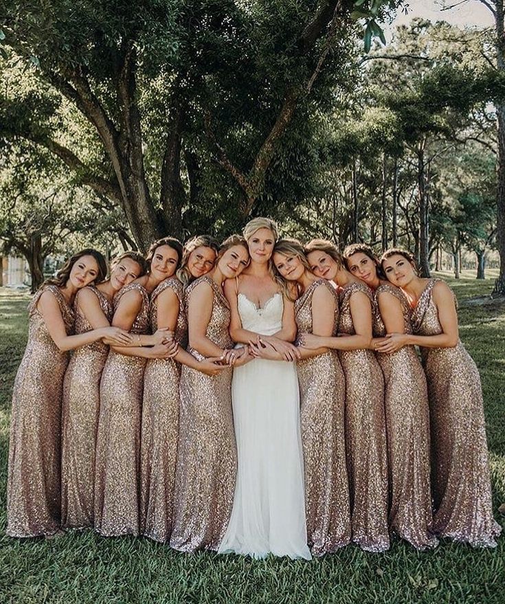 a group of women standing next to each other on top of a lush green field