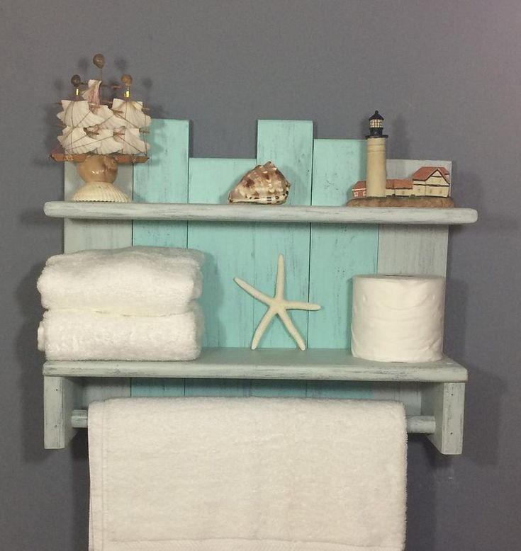 a shelf with towels and other items on it in a bathroom area that is painted blue