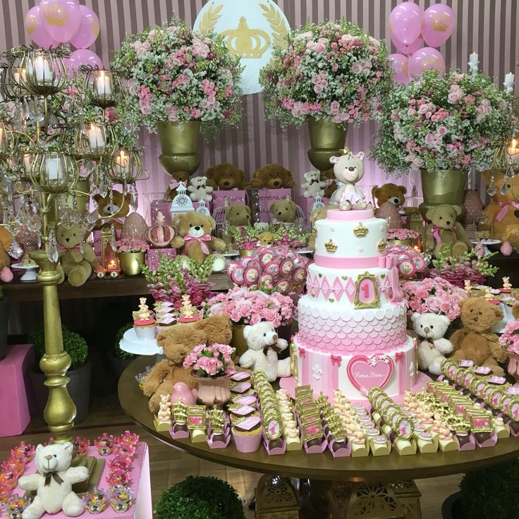 a table topped with lots of teddy bears and cakes