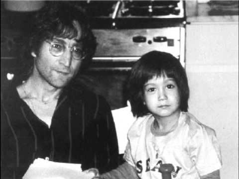 an old photo of a man and child in the kitchen