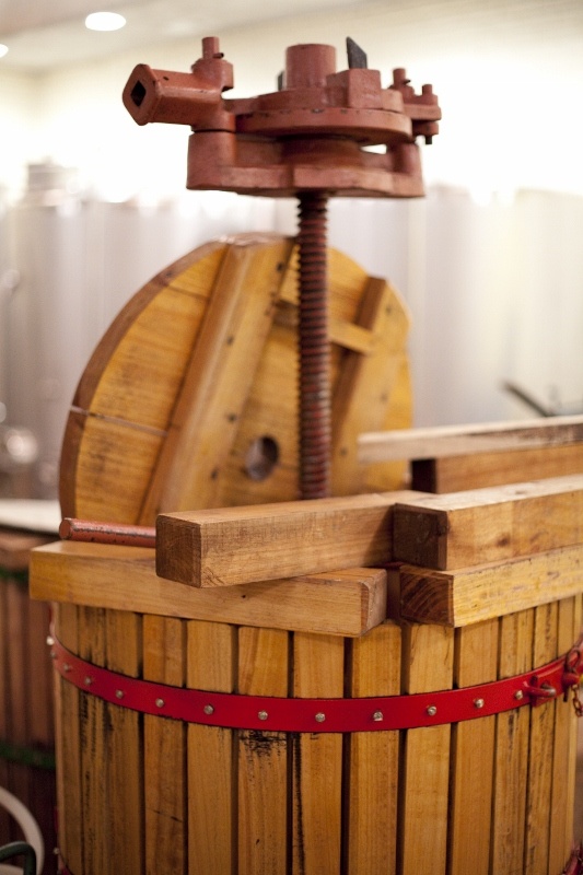 a wooden bucket with a machine in it's center and red ribbon around the bottom