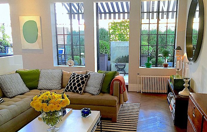 a living room filled with furniture and lots of windows