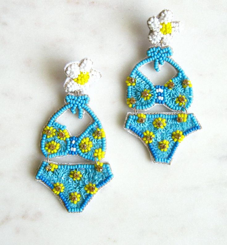 Bikini seed bead earrings - Blue and yellow Drop length 3 inches, width 1.5 inches Large dramatic statement earrings Back of the earring is white felt Summer earrings I fully guarantee all of my items. If you have any problems contact me and I will take care of your concerns. Please contact me with any questions. I am always glad to help. Fun Beaded Dangle Earrings For Beach, Handmade White Beaded Earrings For Vacation, White Beaded Earrings For Summer Vacation, Fun Beaded Earrings For Beach In Summer, Playful Beaded Summer Earrings, Fun Beaded Earrings For Summer, Fun Beaded Earrings For Beach, Fun Beaded Earrings For The Beach, Handmade Blue Beaded Earrings For Beach