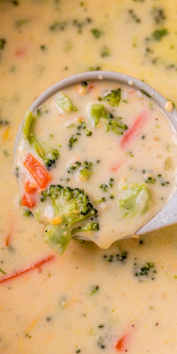 broccoli and cheese soup in a pot with a ladle full of it