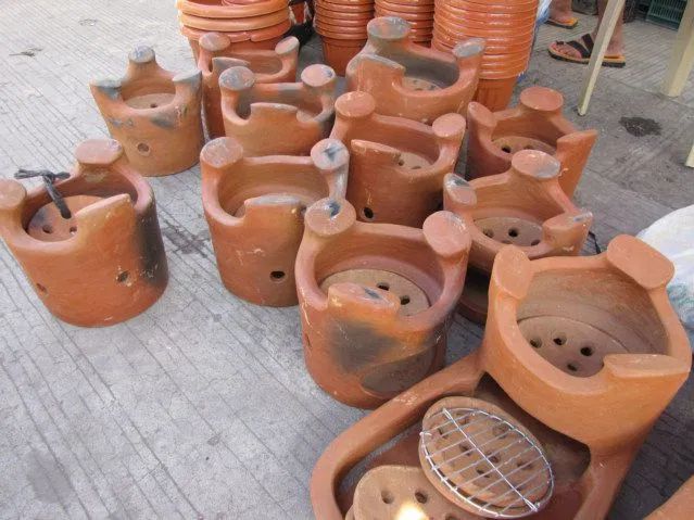 many clay pots are lined up on the ground