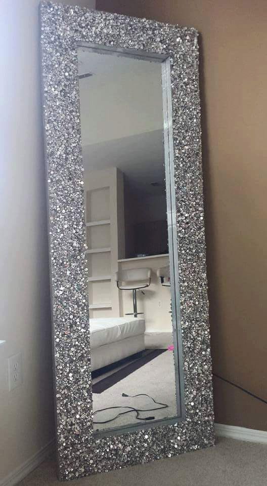 a large mirror sitting on top of a carpeted floor next to a white wall